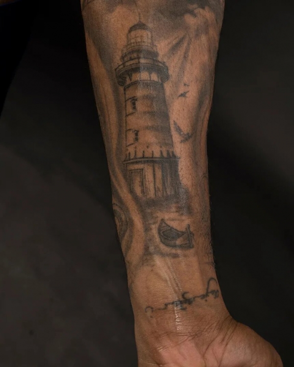 Lighthouse on his left forearm